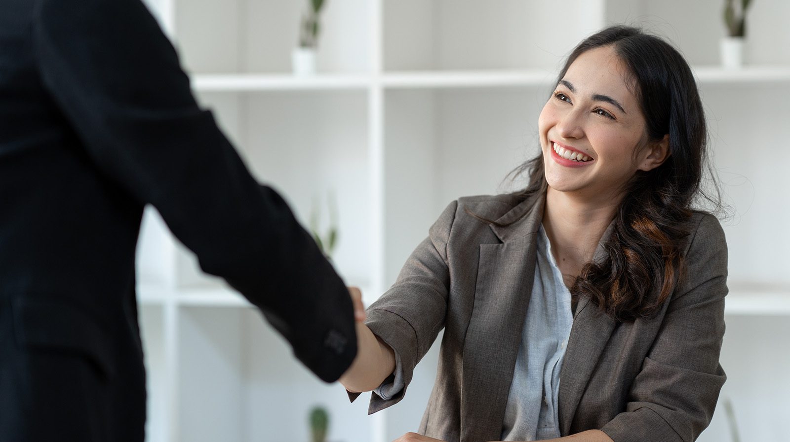 Boss gives handshake to employee