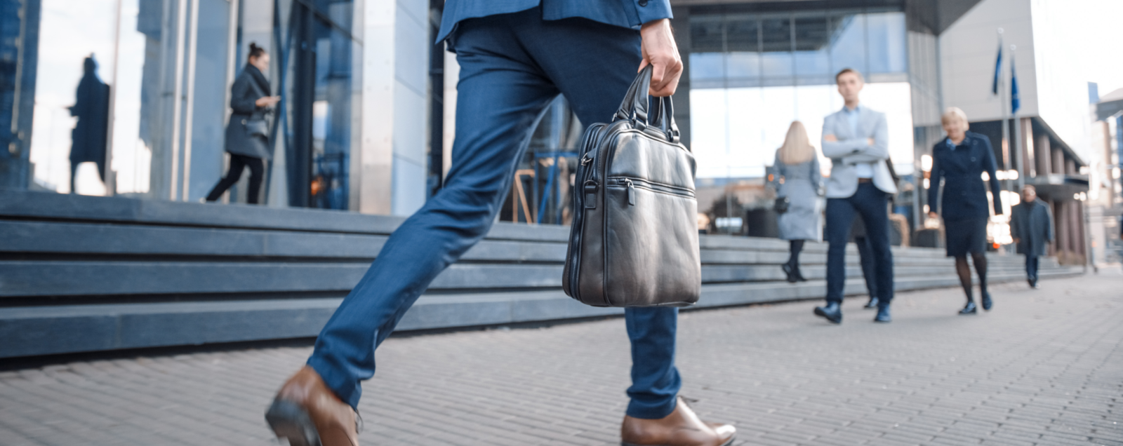 man walking away with a briefcase