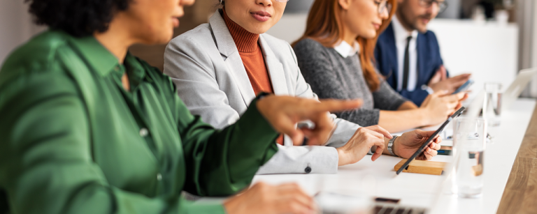 4 people discussing during a meeting at a table